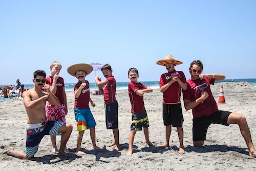Photo of kids on the beach with their camp counselors