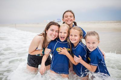 Photo of kids playing in the ocean